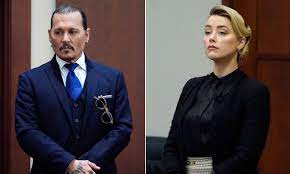 Johnny Depp In Blue Suit And Amber Heard In Black Dress Standing In The Trial Court