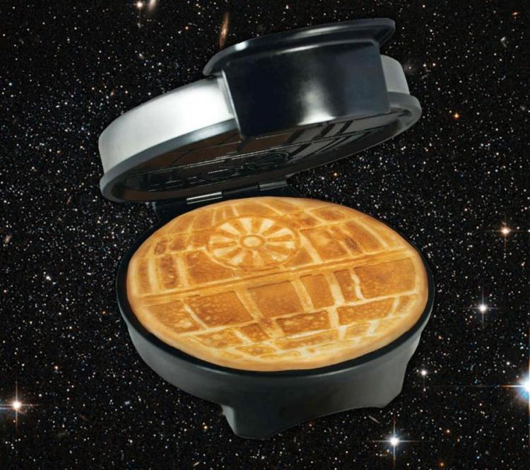 Skin-brown star wars themed pancake in a black colored star wars themed pancake maker on a galaxy bg