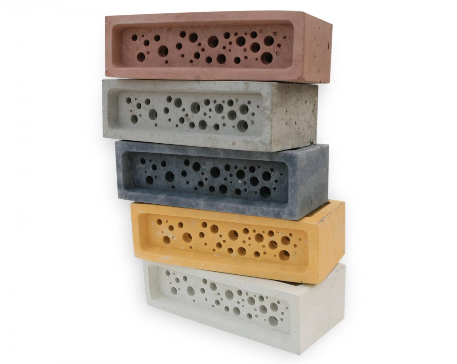 Yellow, charcoal, red, concrete, and white-colored bee bricks