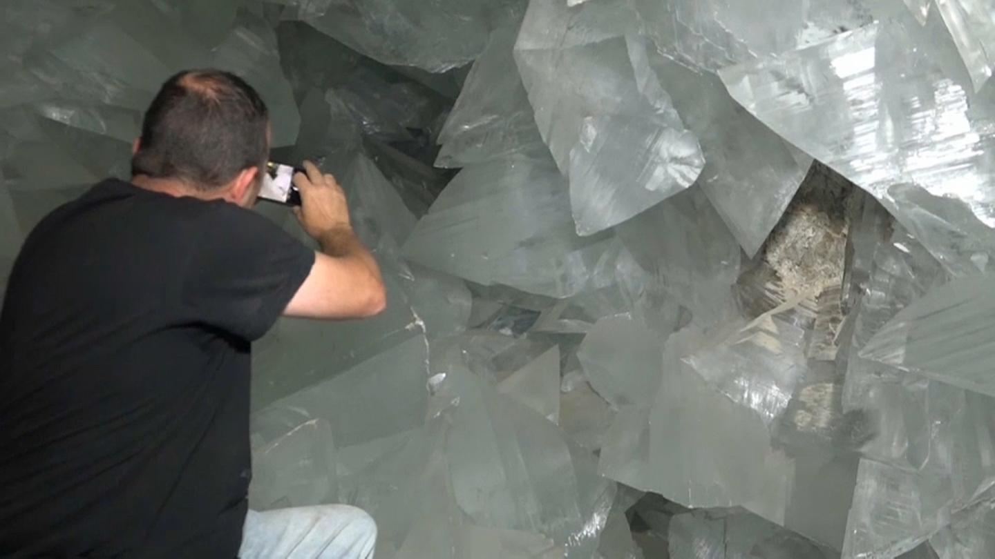 A man taking pictures of giant ice crystals in crystal cave