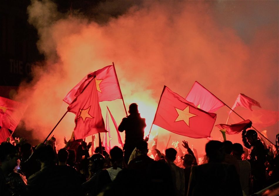 People waving vietnamese flags during a protest or maybe a clebration