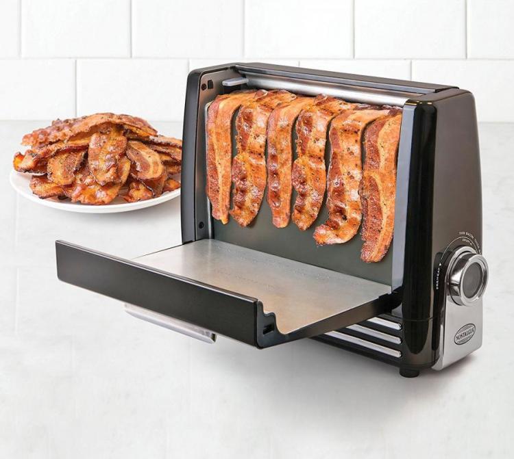 6 slices of bacon cooking in the bacon express in front of a bowl of cooked portions of bacon
