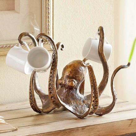 Rusty golden-brown colored Octopus Coffee Mug Holder on a wooden bench