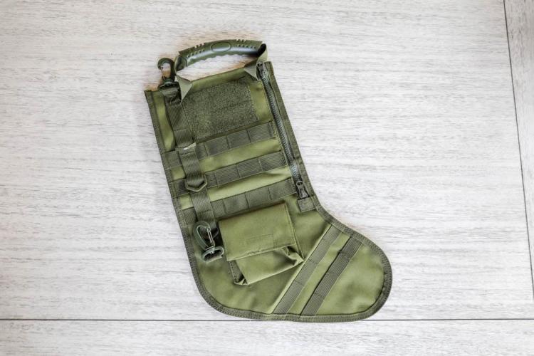 Green-colored Tactical Christmas Stocking on a white wooden top