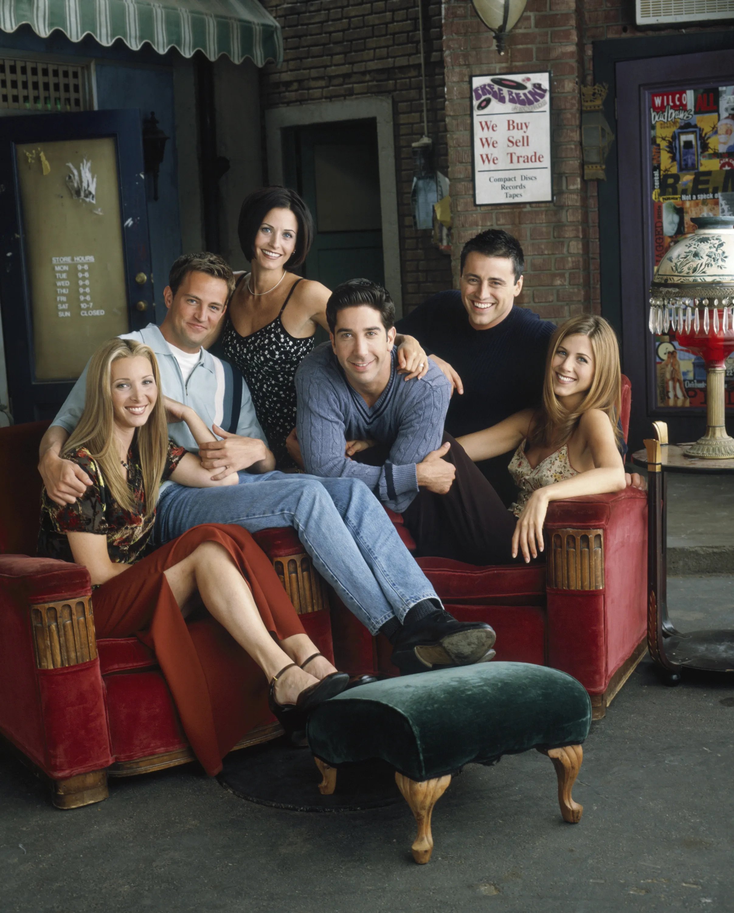 The six main characters of friends sitting on sofas