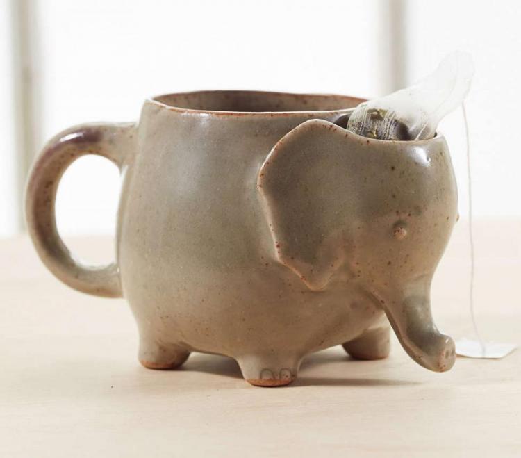 A brown colored cute elephant-shaped mug 