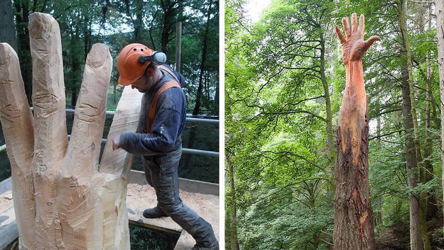 A giant wooden hand sculpted; a chainsaw artist sculpting hand from tree