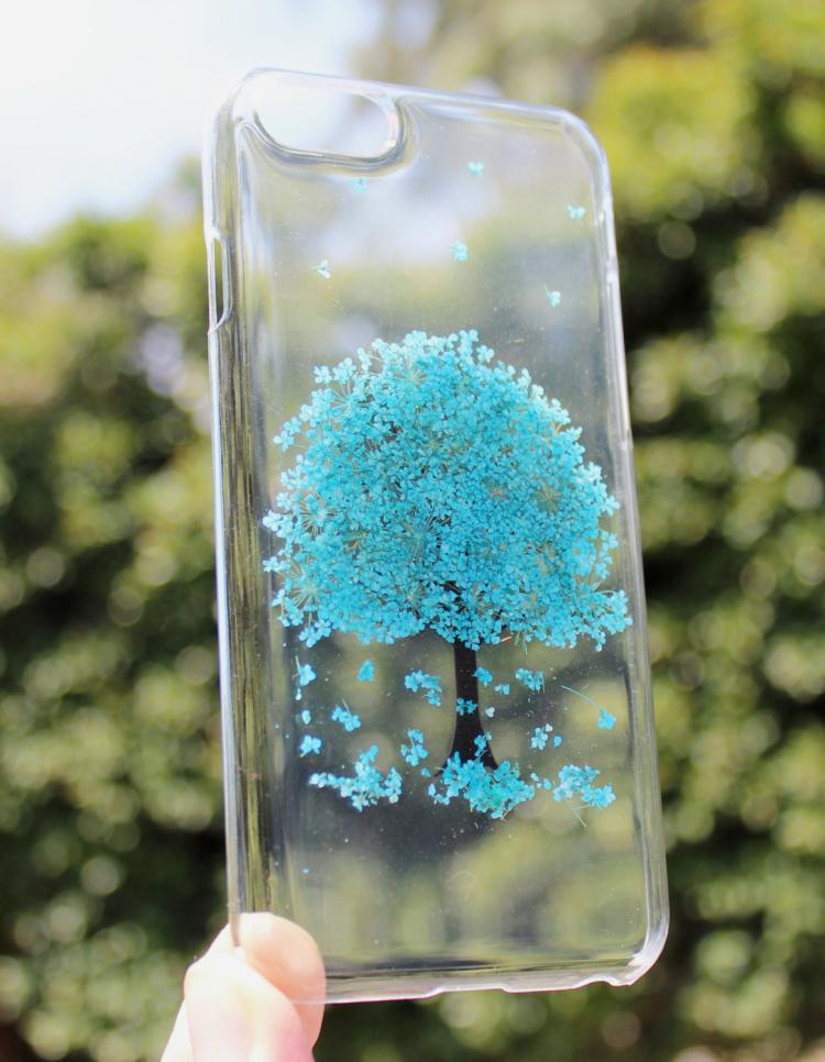 Blue flower tree pressed into a transparent phone case