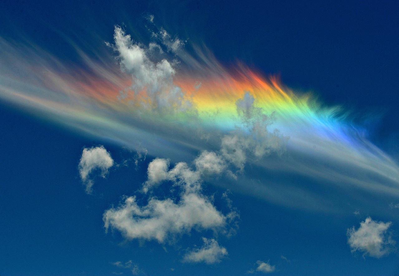 Fire rainbow with clouds on a blue sky