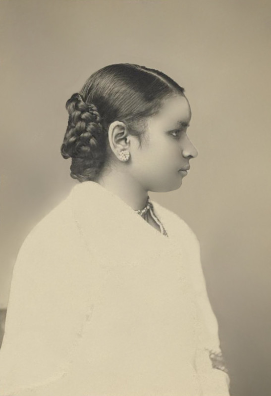 Anandibai Joshee wearing a white dress and her hair tied in a braid