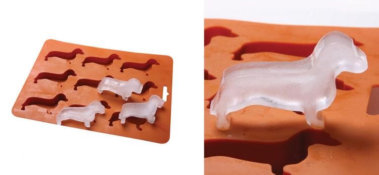 Orange colored wiener dog-shaped ice cube tray filled with wiener shaped ice cubes