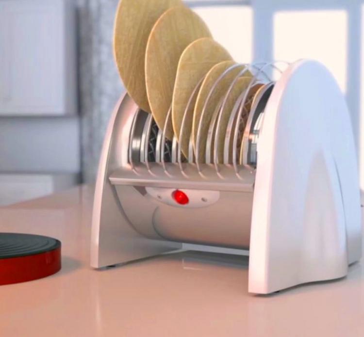 A white segmented tortilla toaster with 5 tortillas in it on a skin kitchen top
