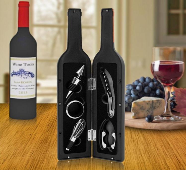 Black colored wine bottle shaped box for wine tools on a brown wooden surface