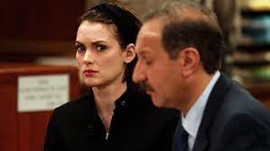 Winona Ryder beside a man in a courtroom