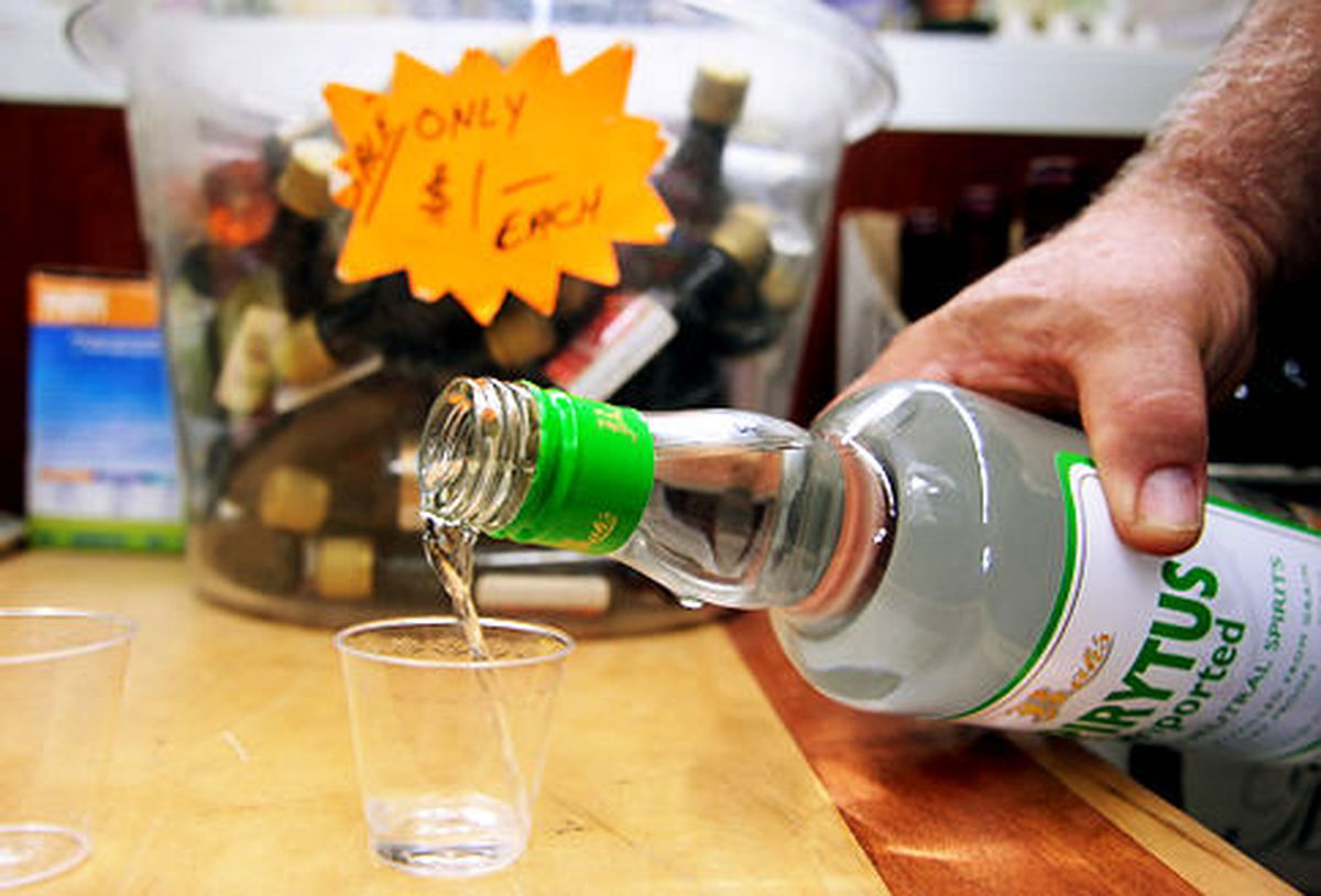 A man is pouring the Spirytus Vodka in a shot glass