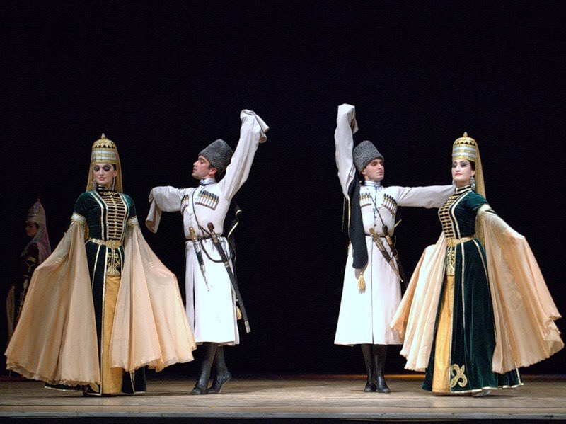 Two couples performing circassian dance on stage