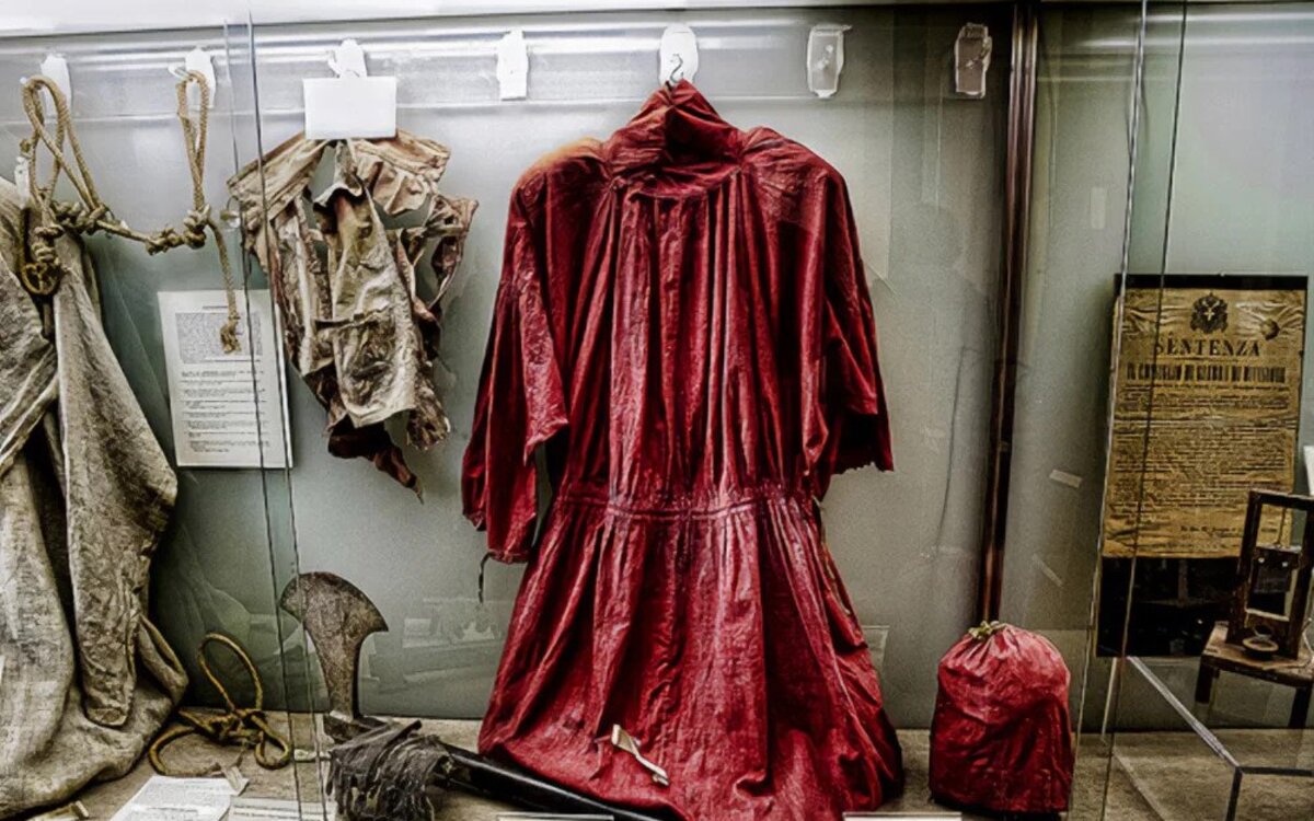 Red robe and axe of Giovanni Battista Bugatti placed in a glass box 