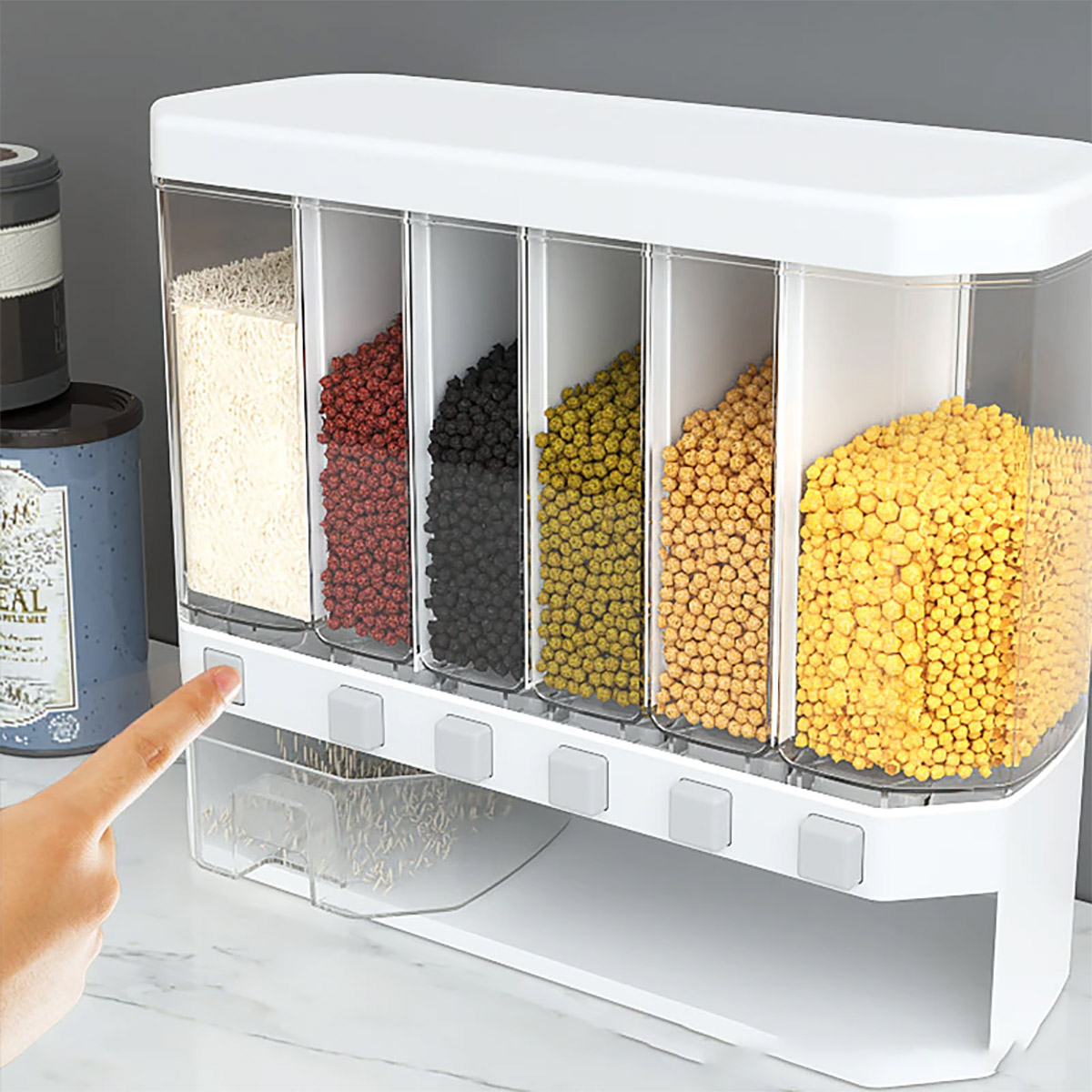 Transparent wall mounted food dispenser filled with multi-colored pulses and rice with a transparent bowl