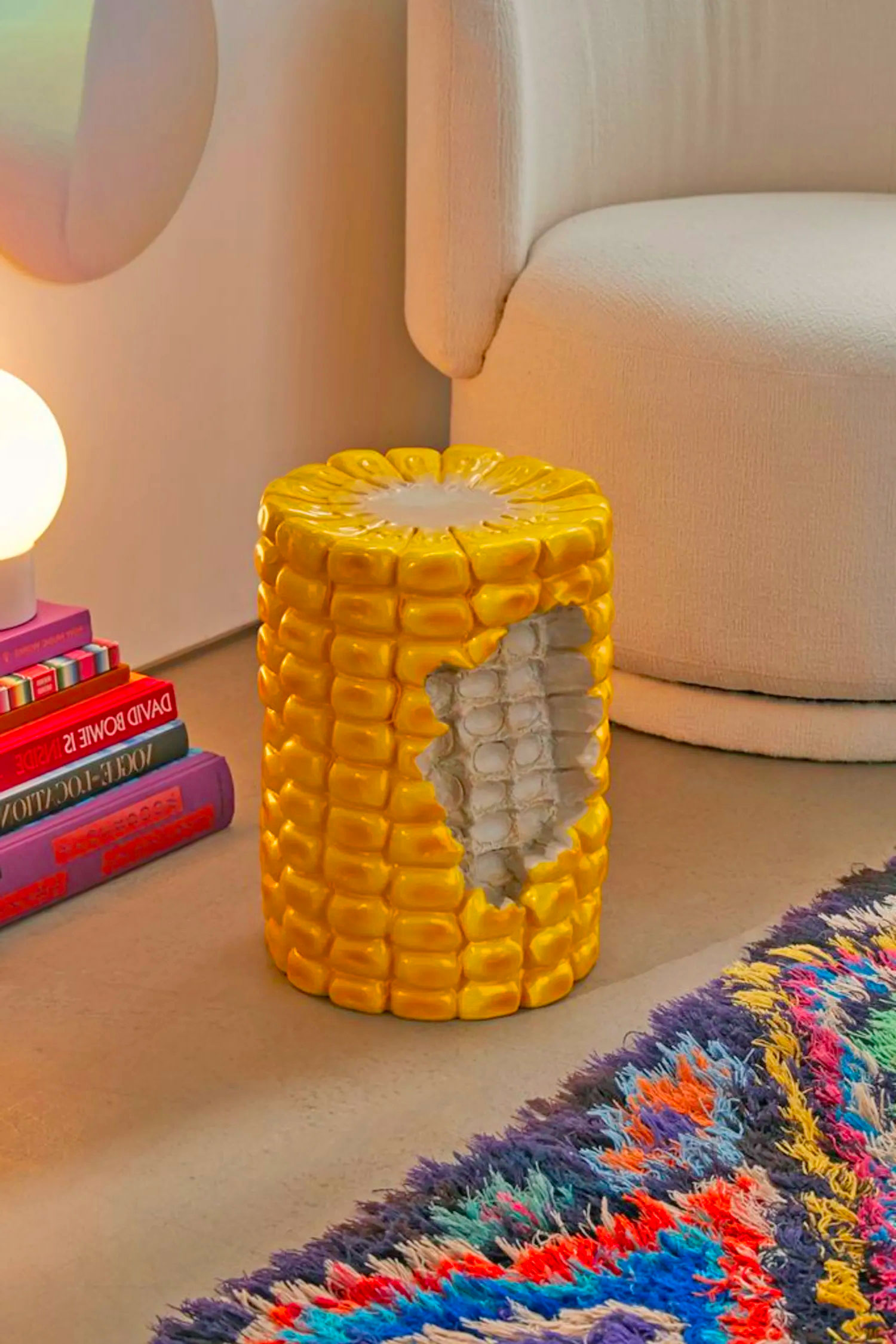 Realistic yellow colored corn cob stool in room
