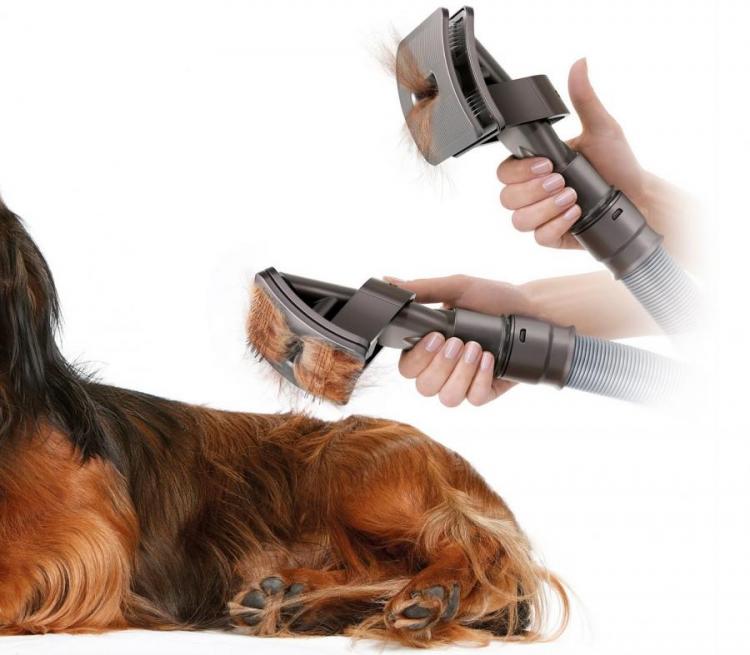 Pet vacuum cleaner removing black and brown colored hairy dog's hair