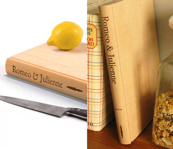 Book shaped cutting board with a lemon on it beside a knife on a white tabletop, book shaped cutting board beside a granola jar