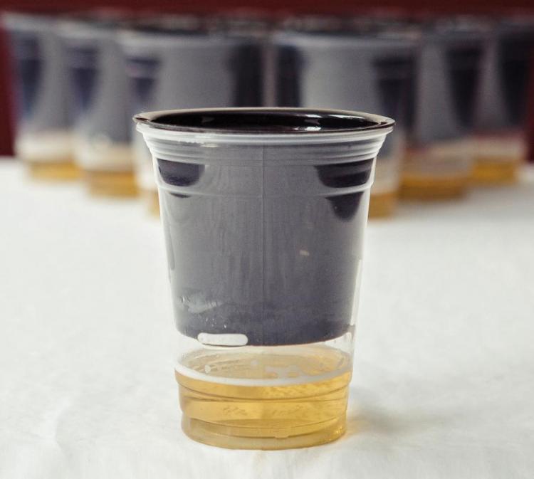 A black plastic cup in a plastic beer cup 
