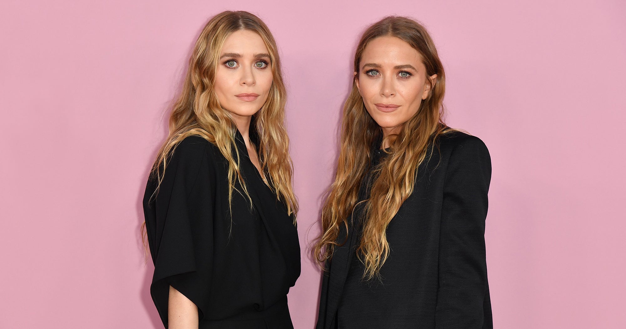 Mary-Kate Olsen and Ashley Fuller Olsen wearing matching black dresses