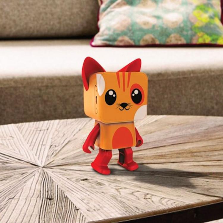 An animated cat-themed orange and red colored Bluetooth speaker on a white-black round table