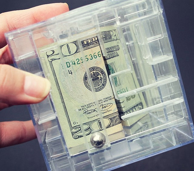 Transparent square box bank with a $20 inside it