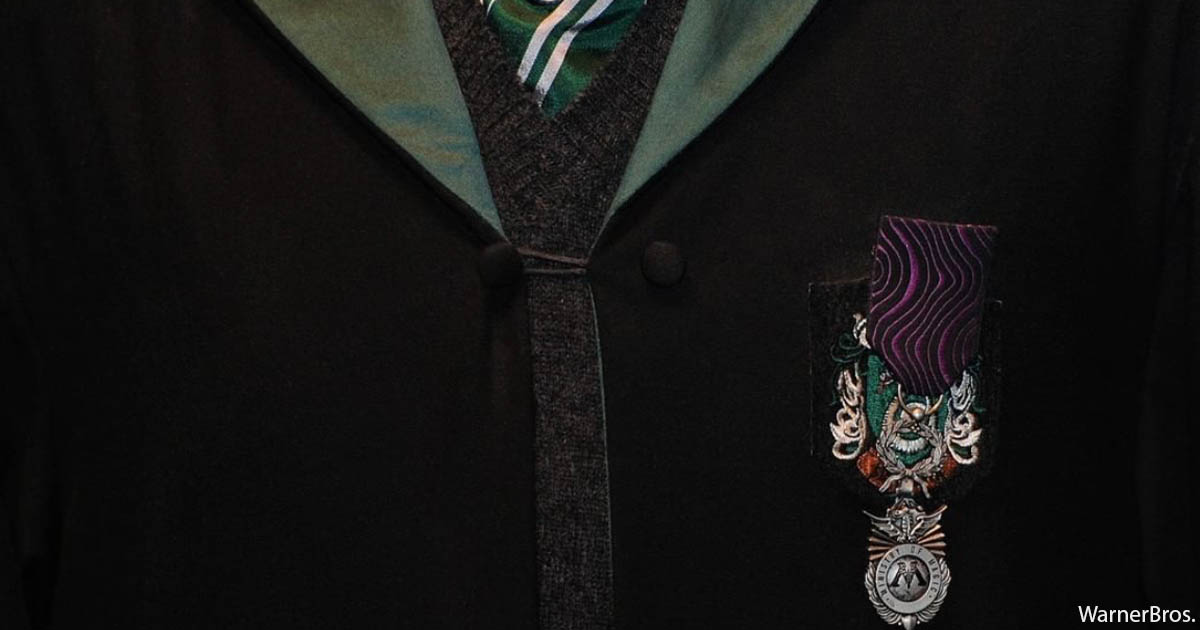 Slytherin badge on a black robe