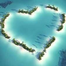 Heart-shaped island covered with plants in the blue sea