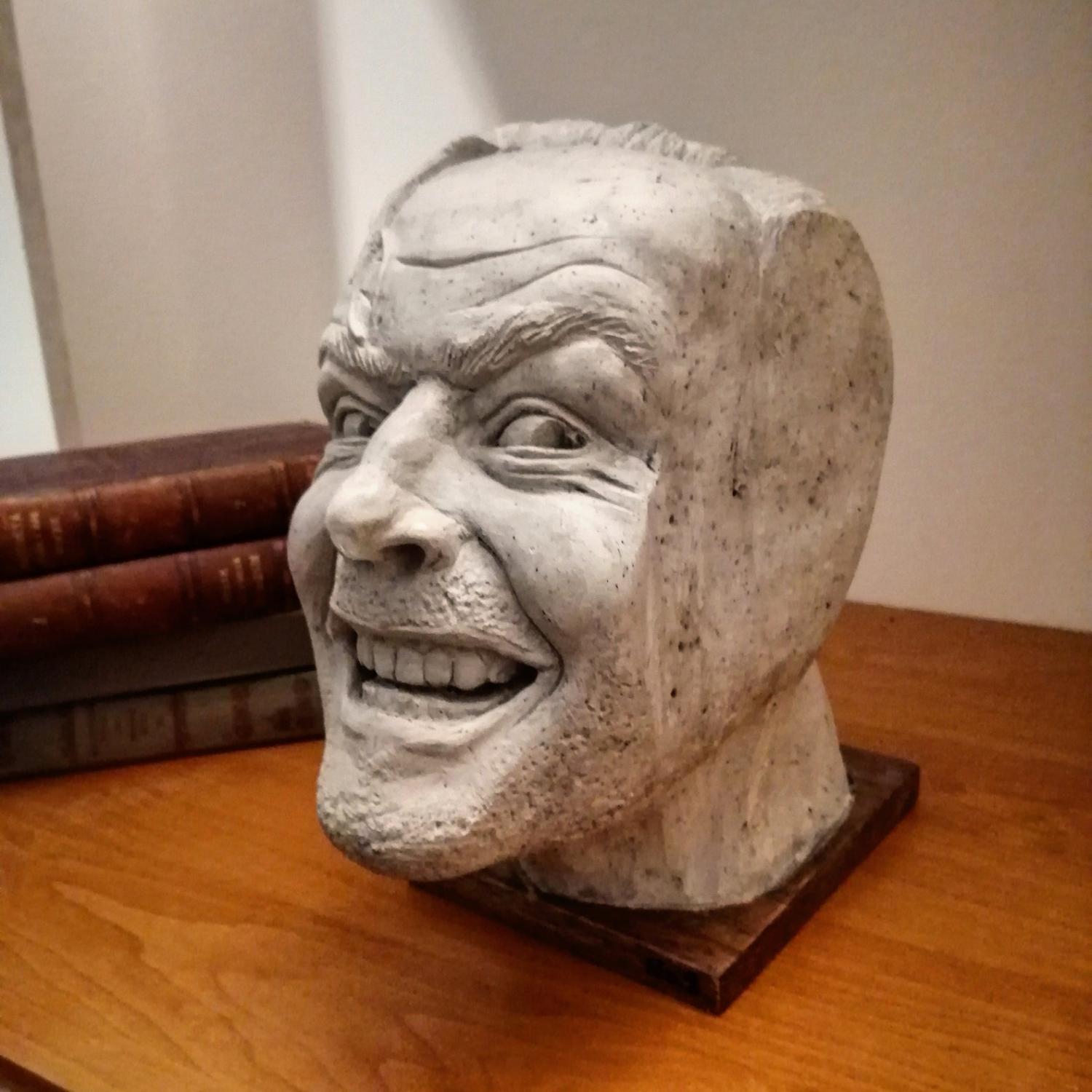 White ceramic 'The Shining' Bookend on a brown wooden floor