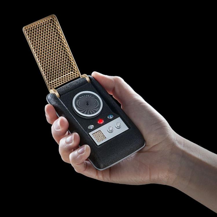 Black colored star trek tos Bluetooth communicator with the golden net held by a man