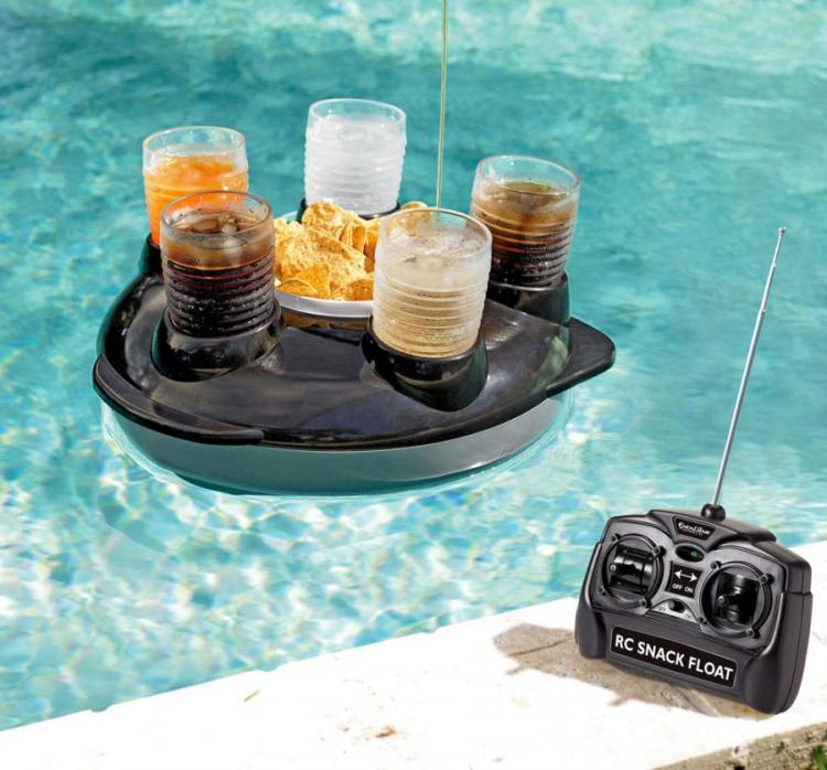 Black colored drink and snack holder holding five different drinks and a bowl of nachos in a pool with remote control on the white marble floor 
