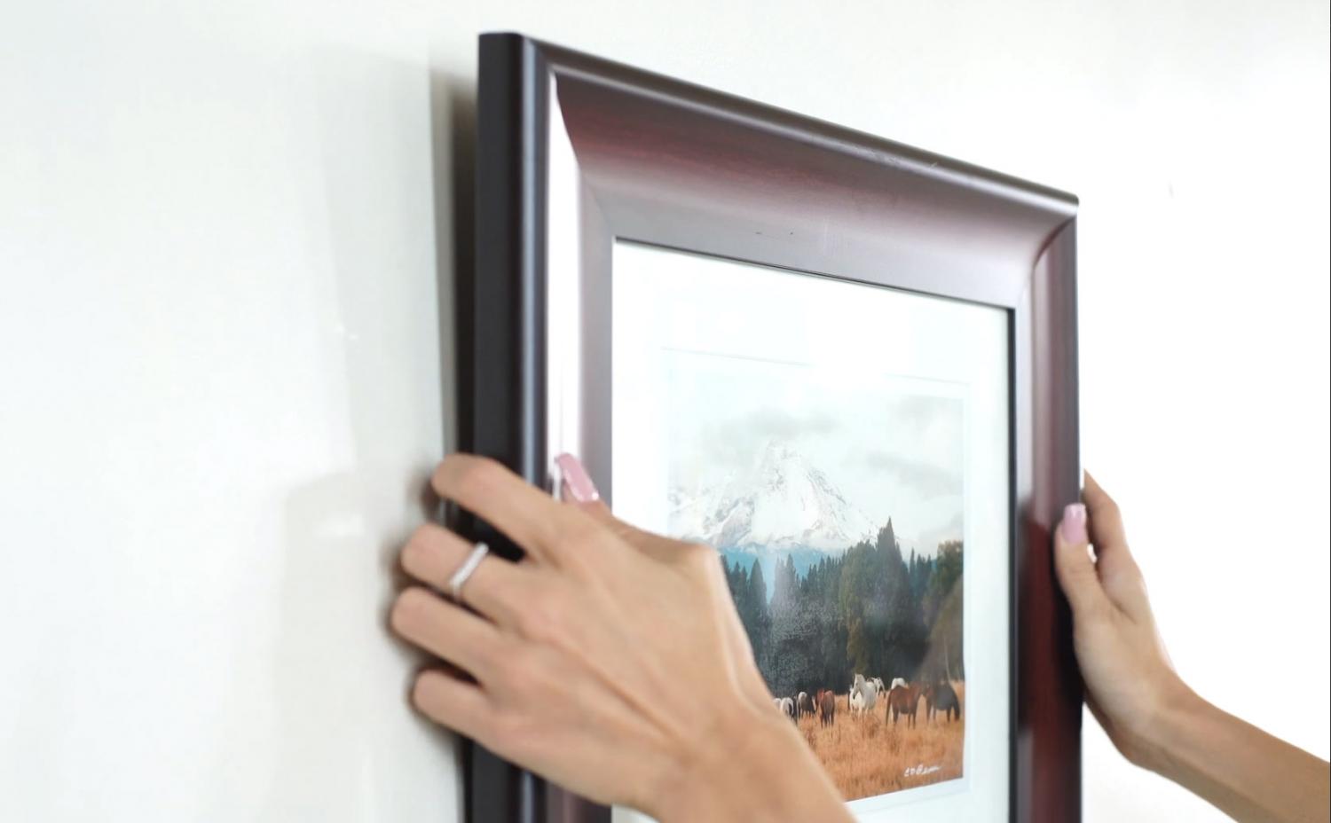 A brown wooden frame picture on a white wall