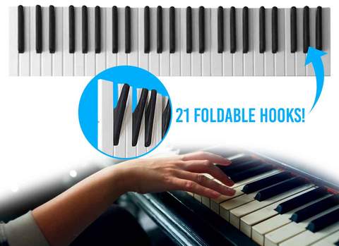 A girl playing the black and white-colored piano; Piano Keys Coat Rack with 21 foldable hooks
