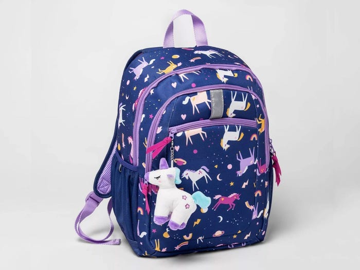 Blue colored backpack with unicorn print on it with a unicorn key chain