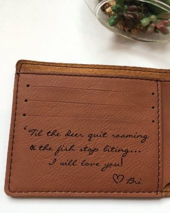 Brown leather wallet with a quote engraved on it