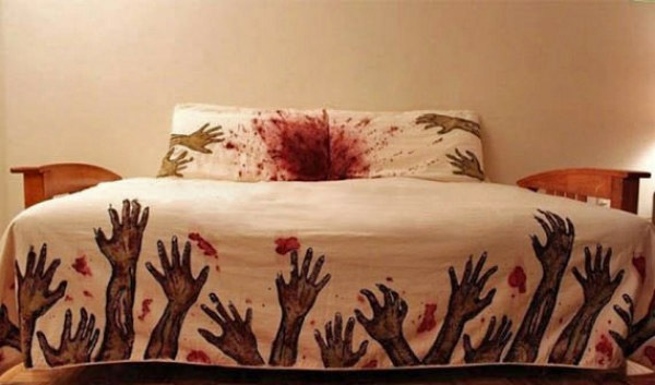 A white-skin bedsheet with bloodied zombie hands on the edges with blood and on the pillows