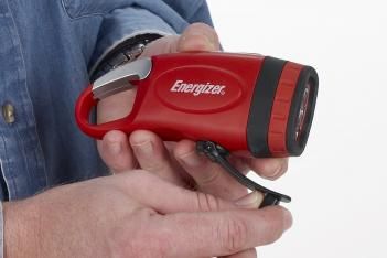 A man holding a red and black energizer flashlight