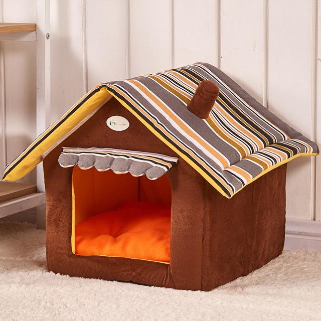 A brown colored dog house on a white rug with grey, brown, and light brown stripes on the top
