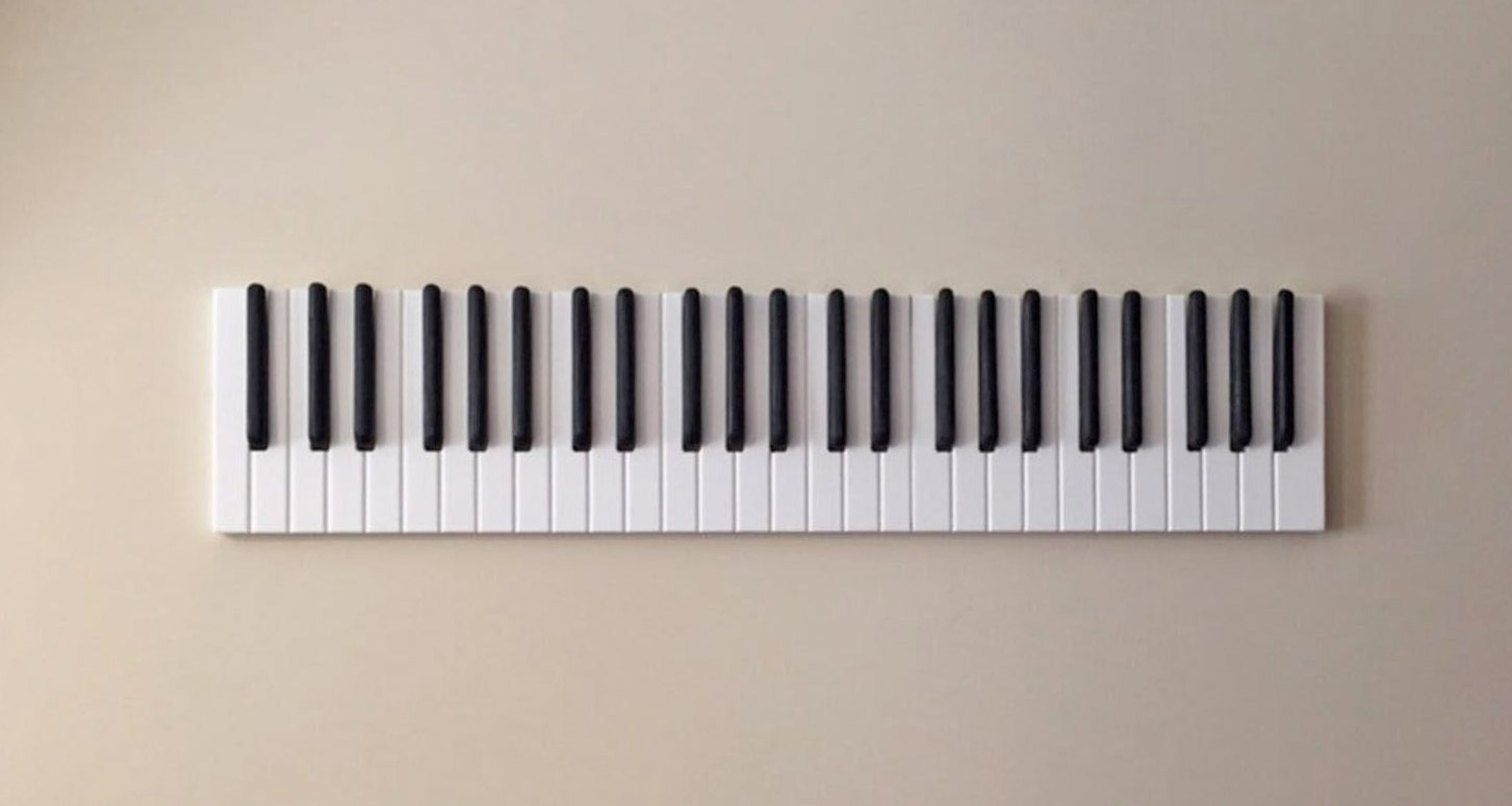 Piano Keys Coat Rack gadget on a skin-colored wall