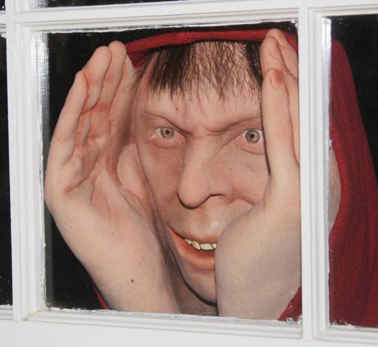 A realistic peeper wearing red cap peeping through the white boundary window