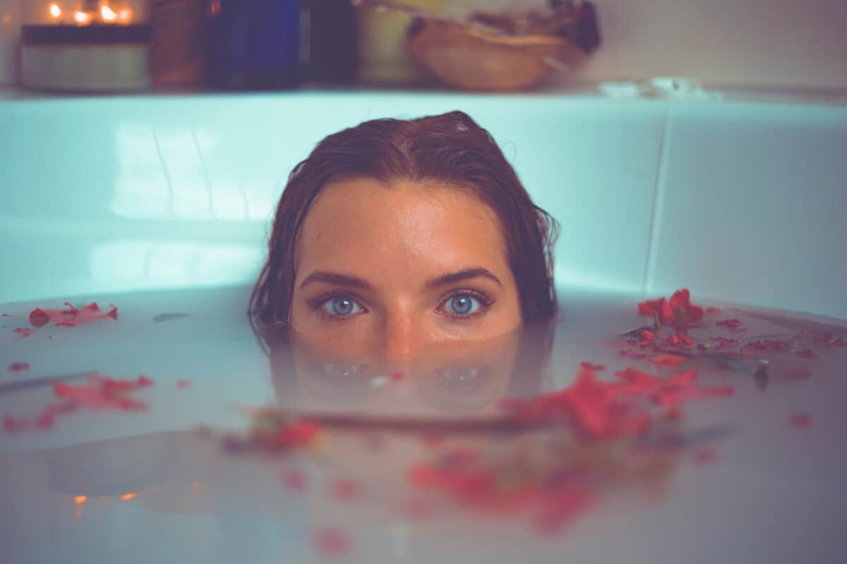 A girl's half face outside the bath tub