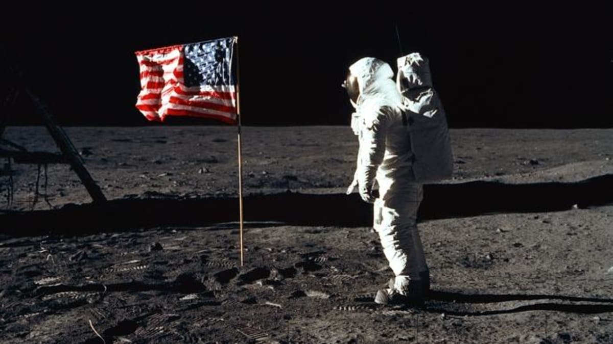 Neil Armstrong wearing space suit when he landed on the moon and put the US flag