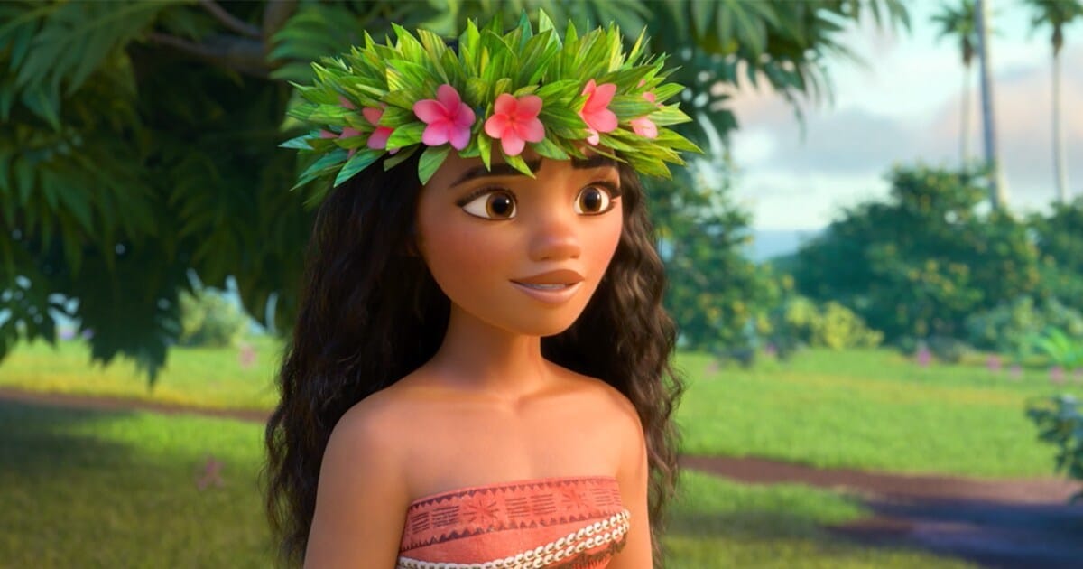 Moana wearing a flower band and standing in garden area
