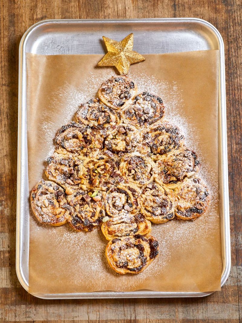 Buddy's mince pie pinwheels in an oven tray with sprinkled white powdery sugar on top