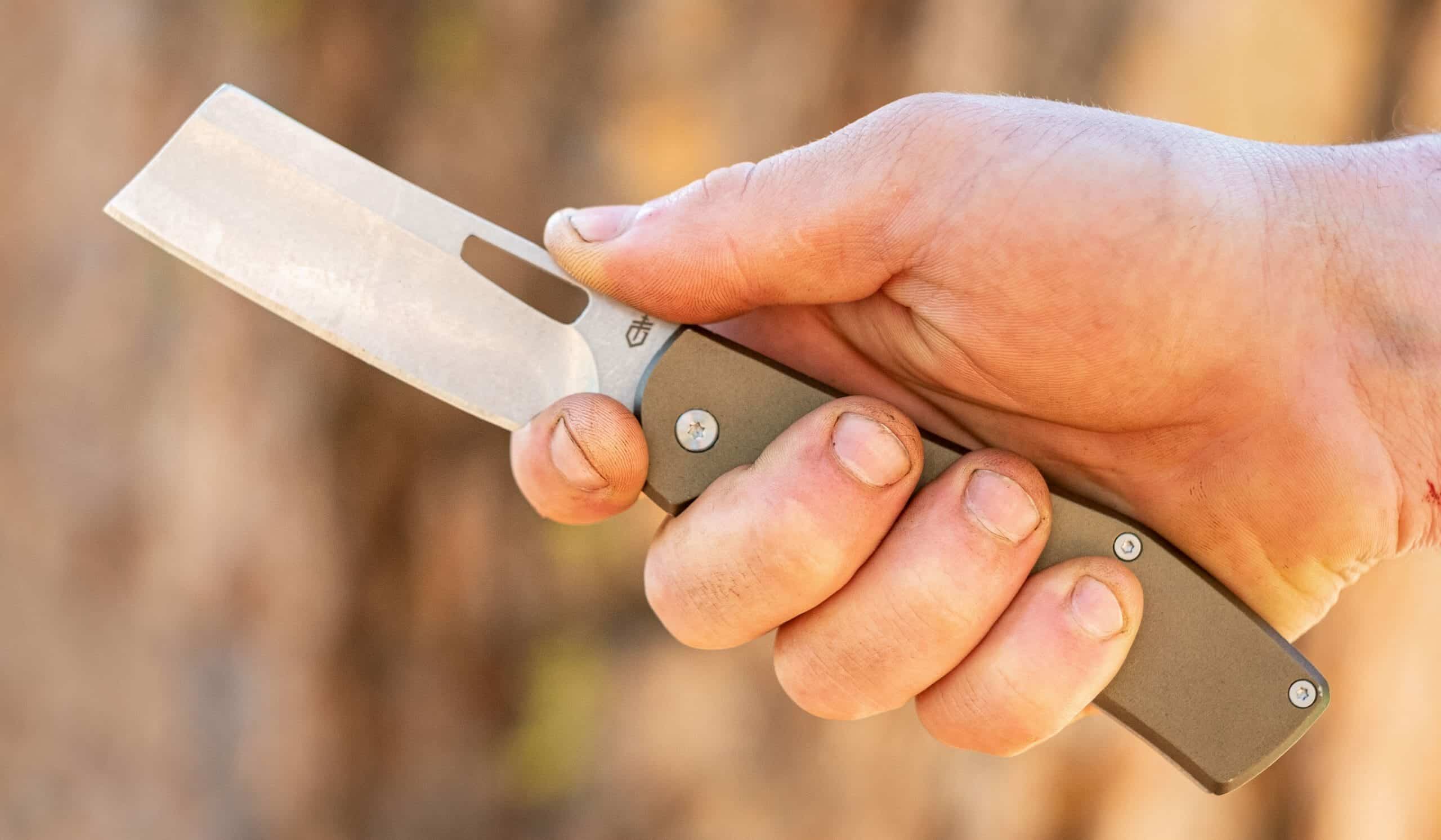 A hand holding a Folding Cleaver