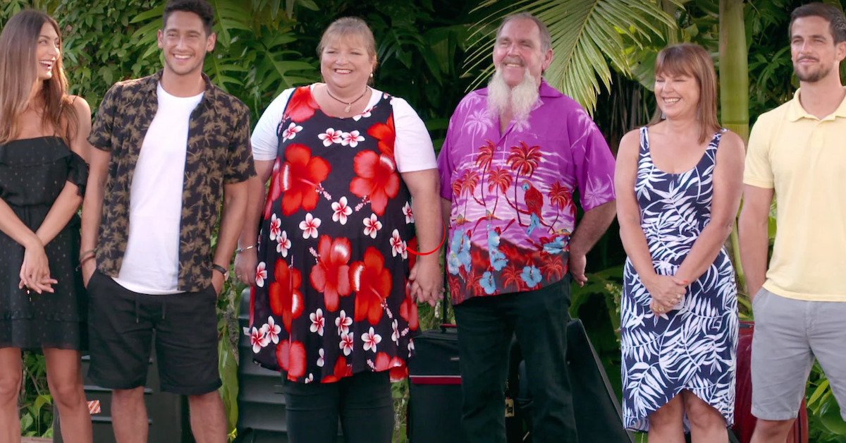 A group of people standing in a garden and laughing