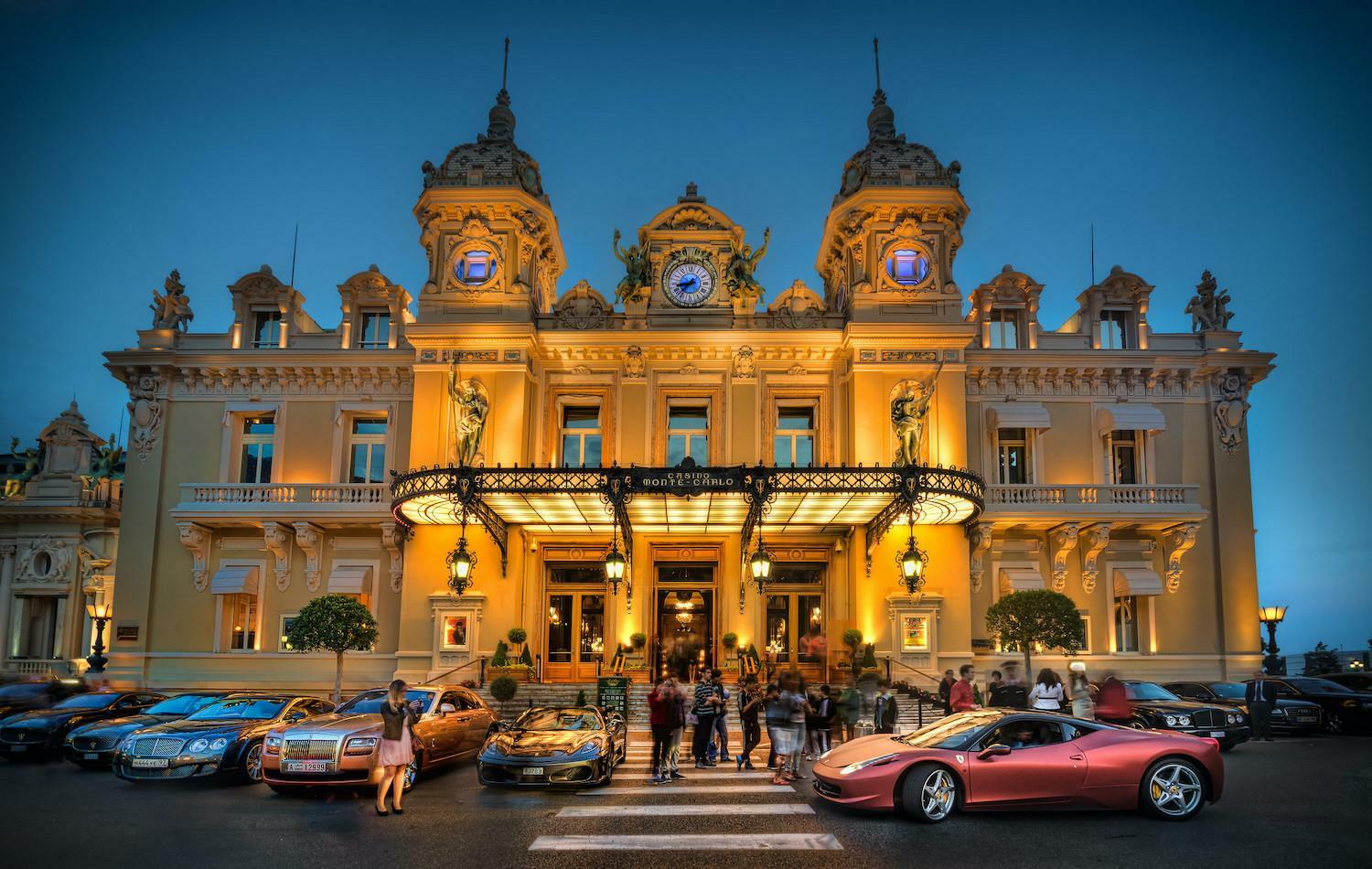 An outside view of luxurious Monte Carlo casino with a lot of luxurious cars